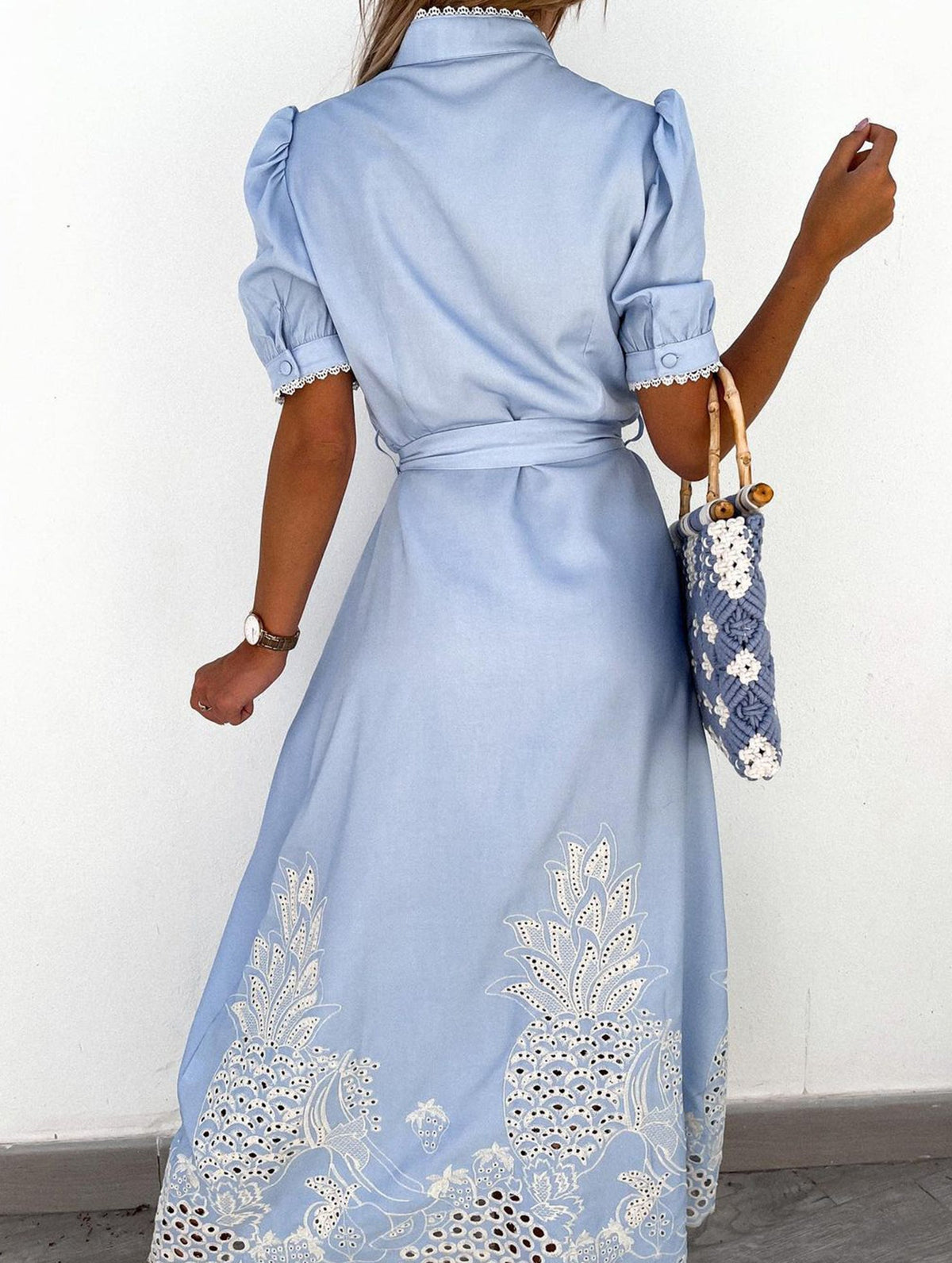 White pastoral style openwork embroidered dress by Christine Brewer, featuring intricate embroidery and a flowing silhouette.
