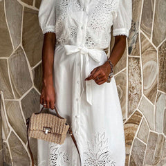 White pastoral style embroidered openwork dress by Christine Brewer, featuring delicate embroidery and flowing fabric.