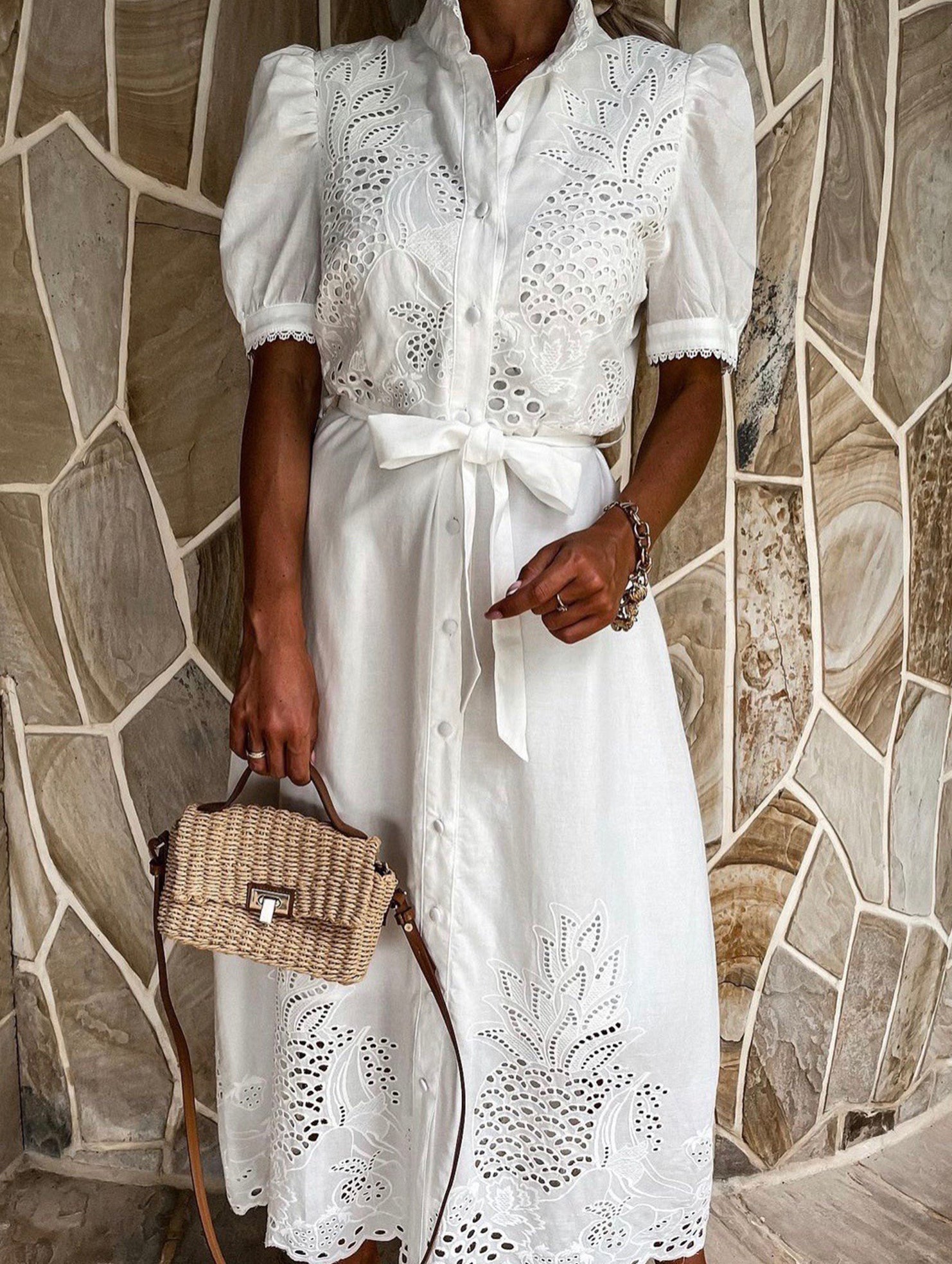 White pastoral style embroidered openwork dress by Christine Brewer, featuring delicate embroidery and flowing fabric.