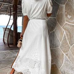 White pastoral style openwork embroidered dress by Christine Brewer, featuring intricate embroidery and flowing fabric.