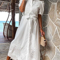 White pastoral style embroidered openwork dress by Christine Brewer, featuring delicate embroidery and openwork details.