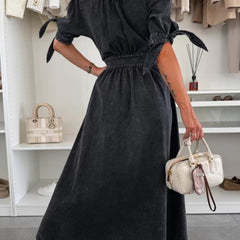 Black deep V-neck fitted shirt dress by Christine Brewer, stylish and elegant, shown on a model with long sleeves and a tailored silhouette.