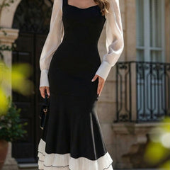Colorblock long sleeve mermaid dress by Christine Brewer, featuring a fitted silhouette and contrasting color blocks in black and white.