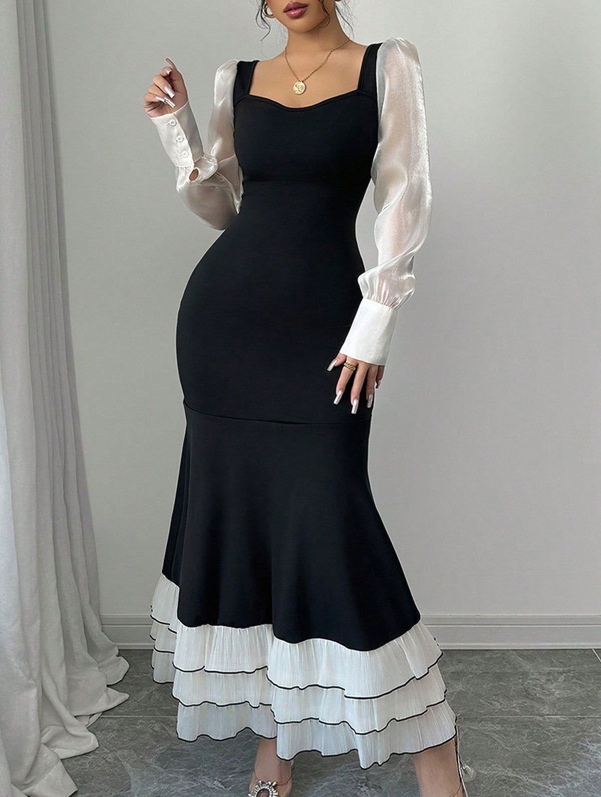 Black colorblock long sleeve mermaid dress by Christine Brewer, featuring a fitted silhouette and elegant design.