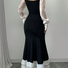 Black colorblock long sleeve mermaid dress by Christine Brewer, featuring a fitted silhouette and stylish design.