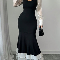 Colorblock long sleeve mermaid dress by Christine Brewer, featuring a white and black design with a fitted silhouette.