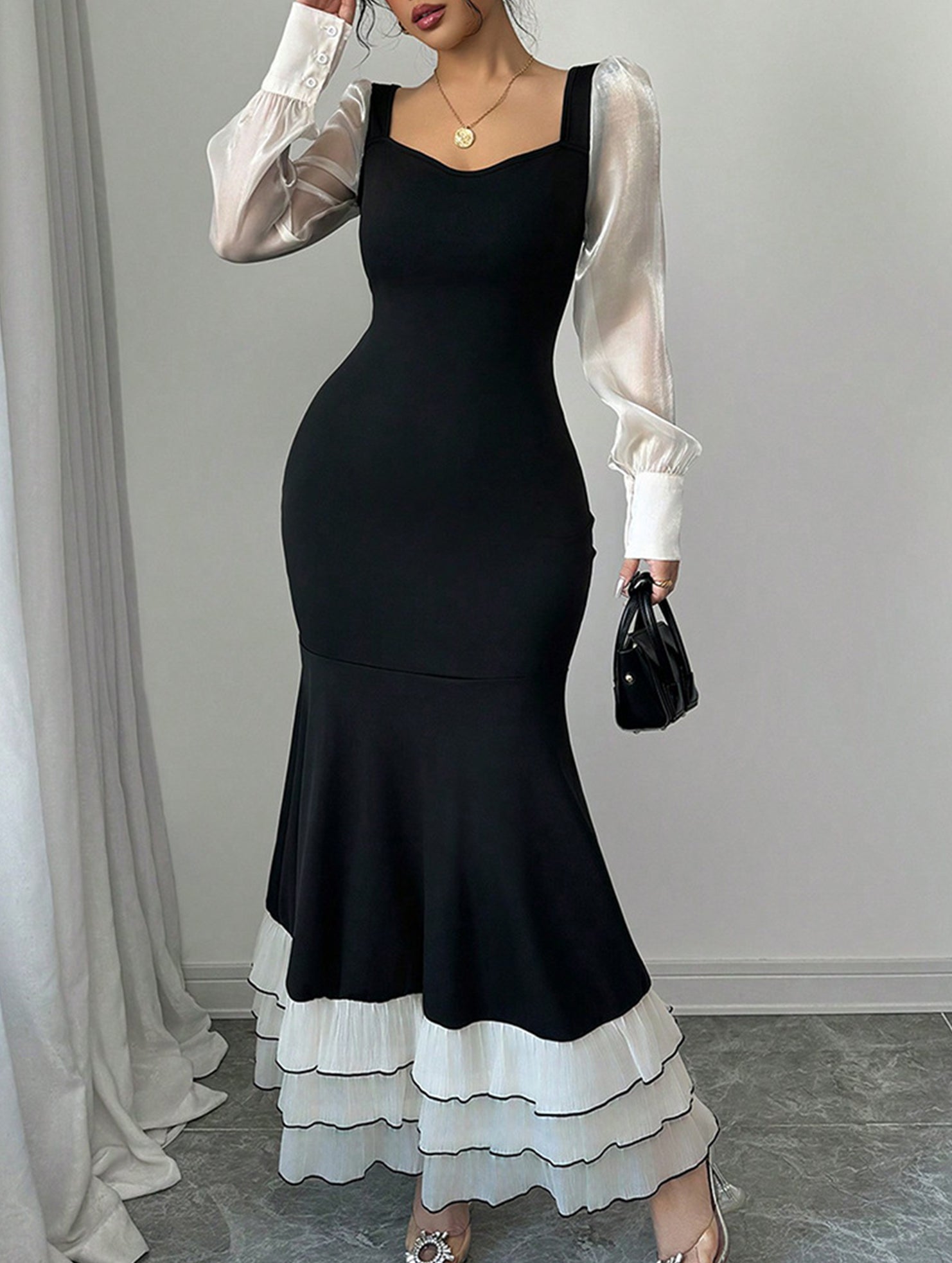 Colorblock long sleeve mermaid dress by Christine Brewer, featuring a white and black design with a fitted silhouette.