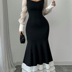 Colorblock long sleeve mermaid dress by Christine Brewer featuring a fitted silhouette and stylish color blocking in black.