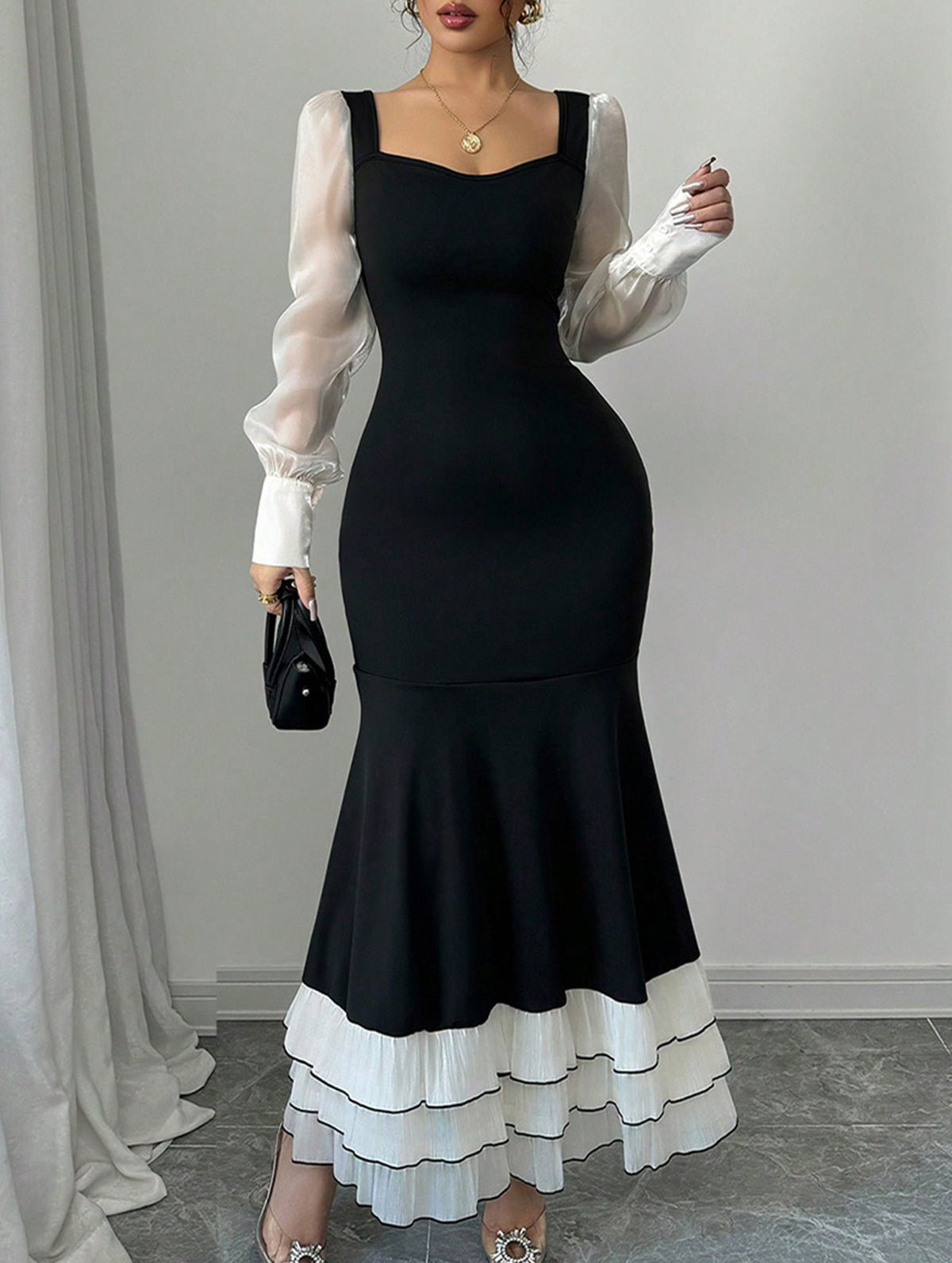 Colorblock long sleeve mermaid dress by Christine Brewer featuring a fitted silhouette and stylish color blocking in black.