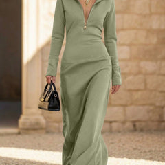White long sleeve maxi dress with a half zip polo collar by Christine Brewer, slim fit, elegant design, photographed on a plain background.