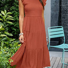 White solid color sleeved dress by Christine Brewer, shown on a hanger with a simple cross-border design.