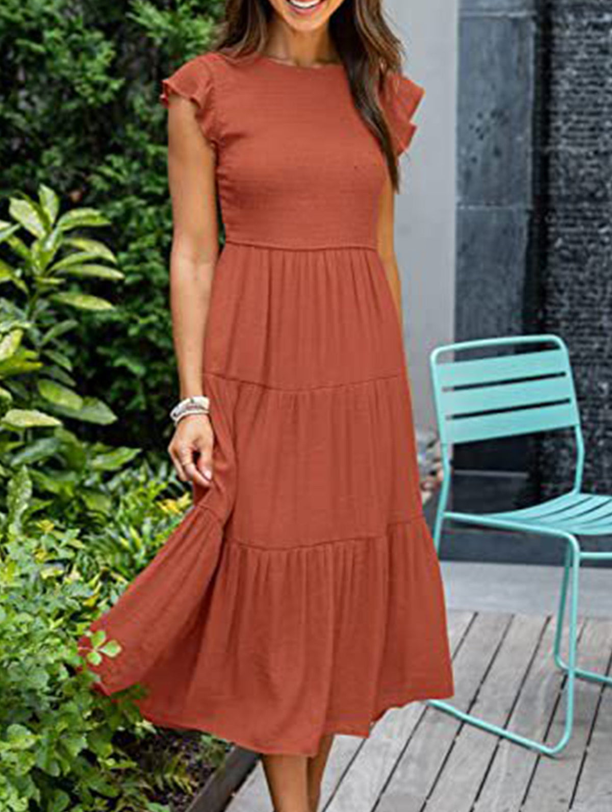 White solid color sleeved dress by Christine Brewer, shown on a hanger with a simple cross-border design.