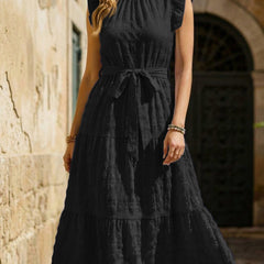 White ruffled flutter sleeve dress by Christine Brewer with tie waist and textured fabric, perfect for casual or semi-formal occasions.