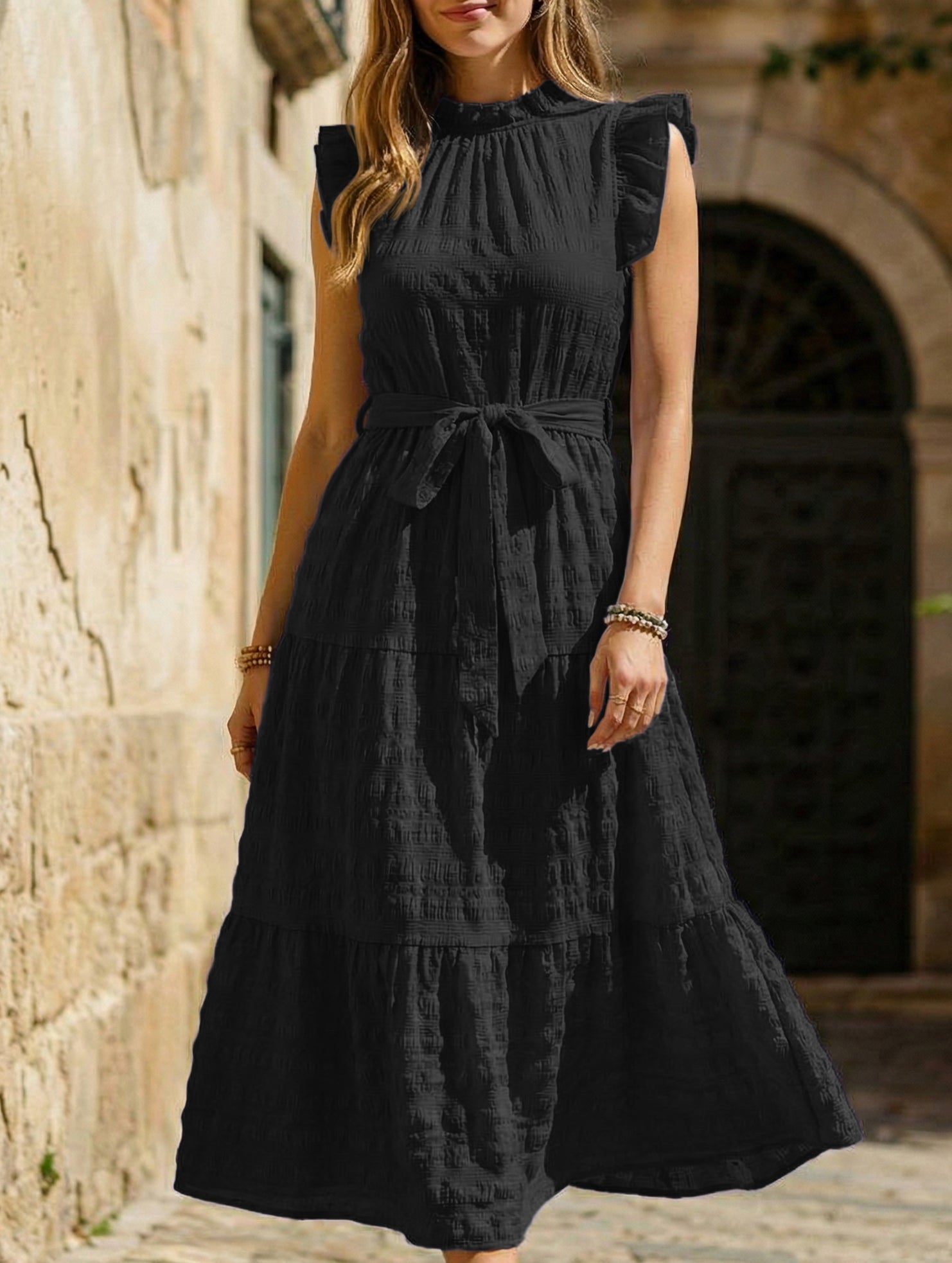 White ruffled flutter sleeve dress by Christine Brewer with tie waist and textured fabric, perfect for casual or semi-formal occasions.