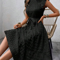 Black ruffled flutter sleeve tie-textured dress by Christine Brewer with a stylish design and elegant silhouette.