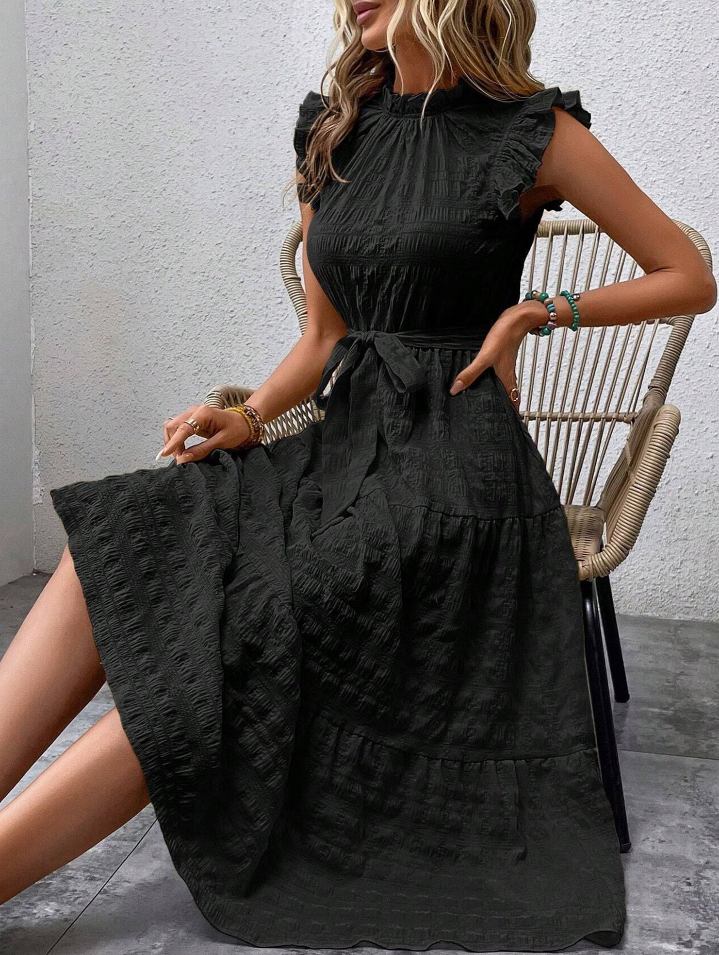 Black ruffled flutter sleeve tie-textured dress by Christine Brewer with a stylish design and elegant silhouette.