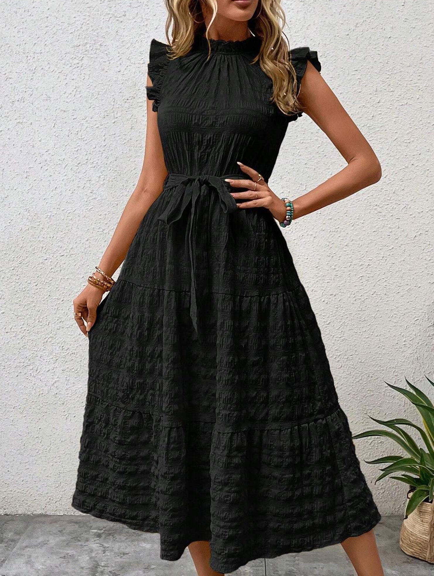 Black ruffled flutter sleeve dress by Christine Brewer featuring tie waist and textured fabric.