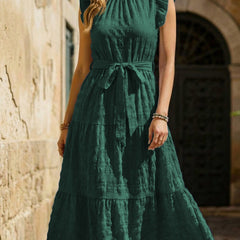 White textured dress with ruffled flutter sleeves and tie waist by Christine Brewer, shown on a model.