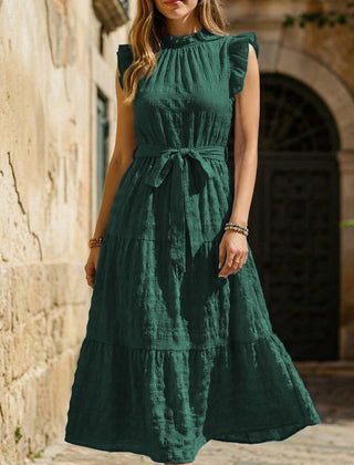 White textured dress with ruffled flutter sleeves and tie waist by Christine Brewer, shown on a model.