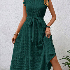 White ruffled flutter sleeve dress by Christine Brewer with tie waist and textured fabric, perfect for elegant casual wear.