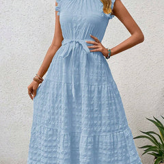 White ruffled flutter sleeve dress by Christine Brewer with textured fabric, featuring a tie detail and a breezy, elegant style.
