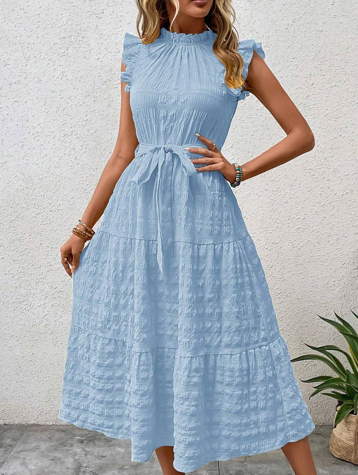 White ruffled flutter sleeve dress by Christine Brewer with textured fabric, featuring a tie detail and a breezy, elegant style.