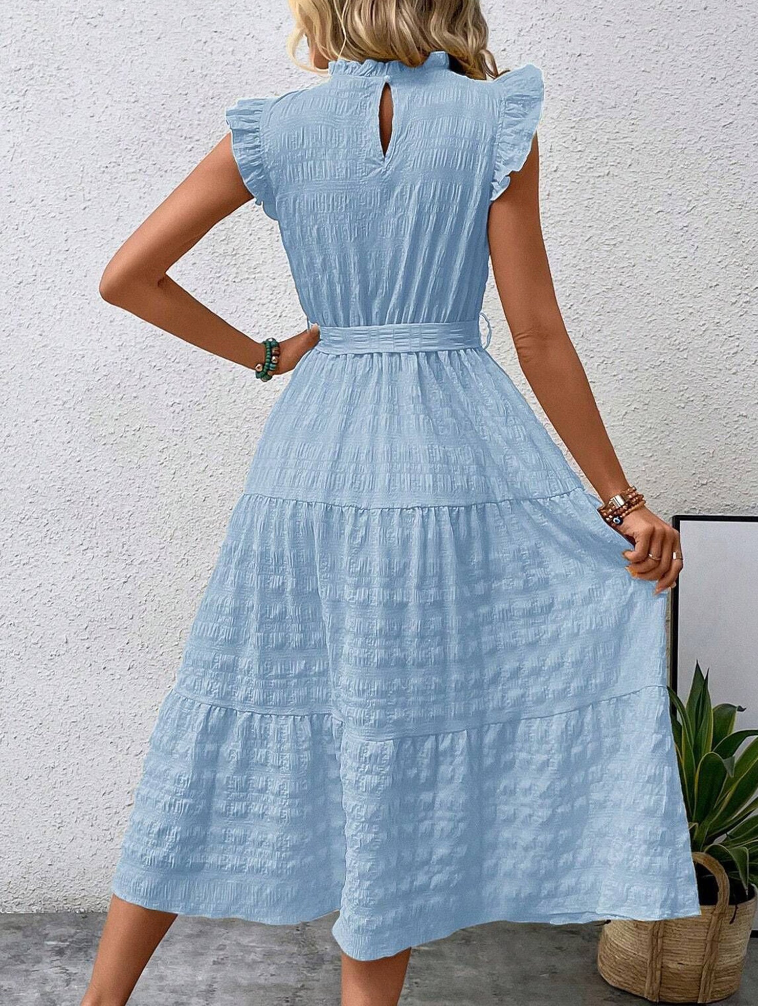 White ruffled flutter sleeve dress by Christine Brewer featuring tie waist and textured fabric, perfect for elegant occasions.