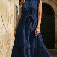 White ruffled flutter sleeve tie textured dress by Christine Brewer, showcasing its elegant design and lightweight fabric.