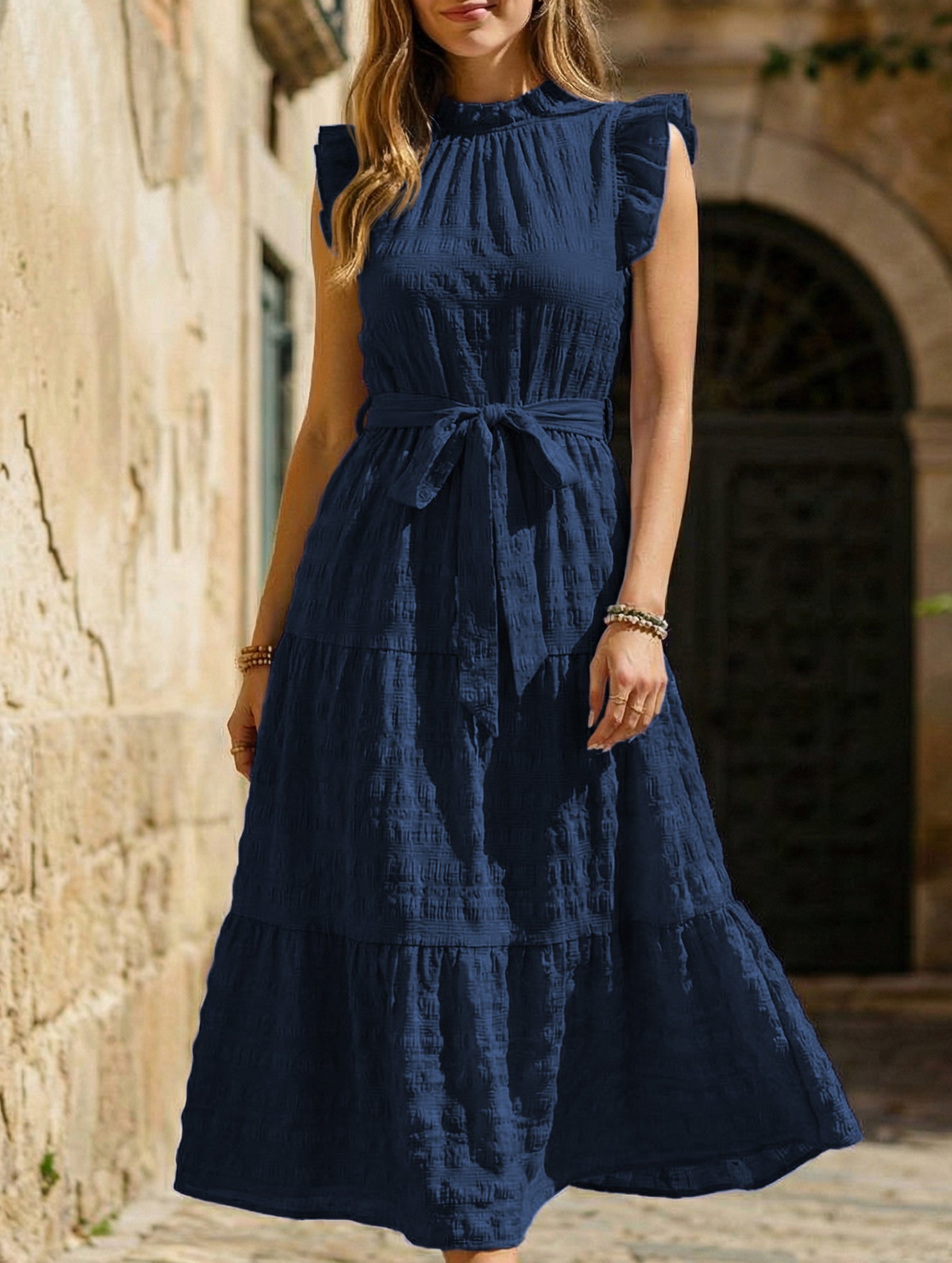 White ruffled flutter sleeve tie textured dress by Christine Brewer, showcasing its elegant design and lightweight fabric.