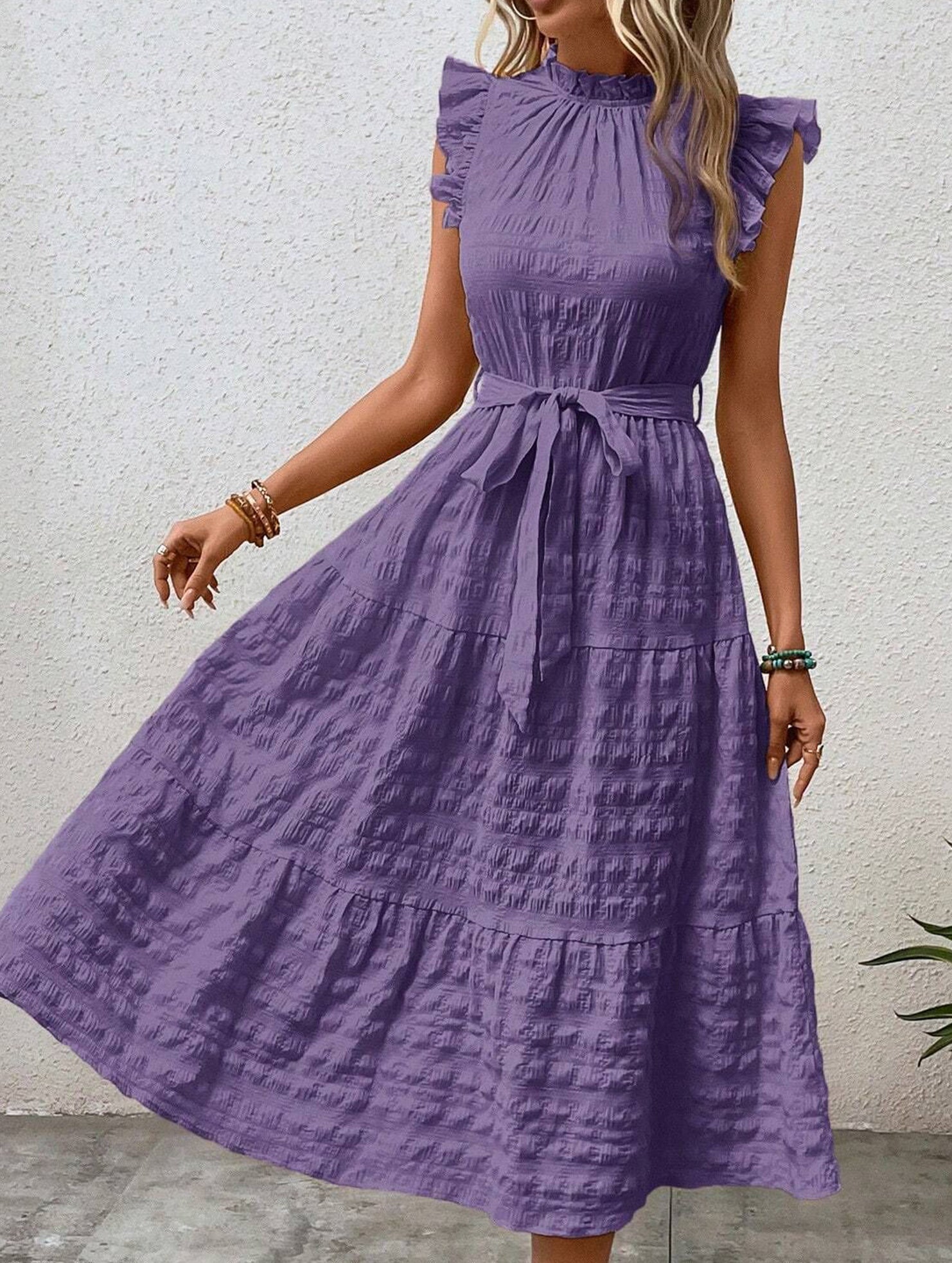 White ruffled flutter sleeve dress by Christine Brewer with tie waist and textured fabric, perfect for casual or semi-formal wear.