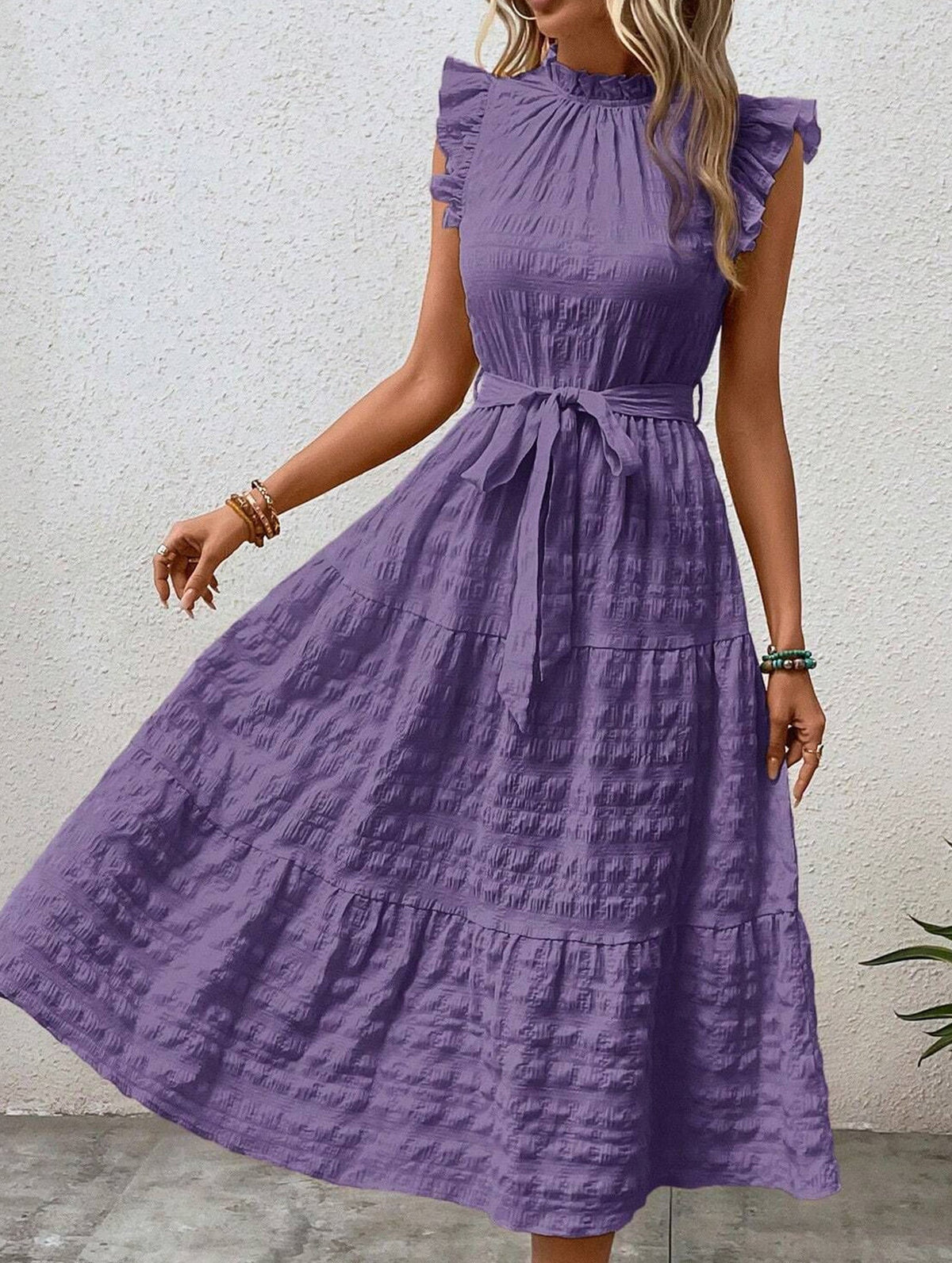 White ruffled flutter sleeve dress by Christine Brewer with tie waist and textured fabric, perfect for casual or semi-formal wear.
