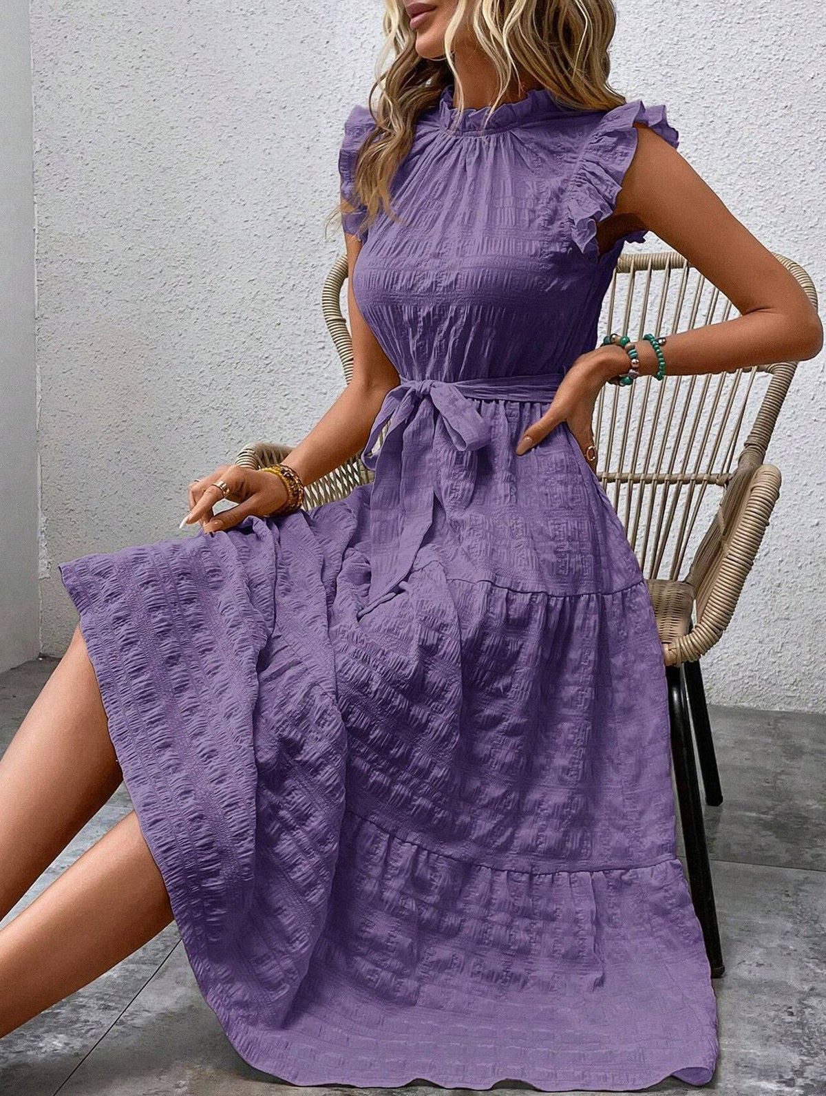 Purple textured dress with ruffled flutter sleeves and tie waist by Christine Brewer, showcasing a stylish and elegant design.