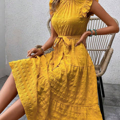 Yellow ruffled flutter sleeve dress by Christine Brewer featuring tie waist and textured fabric design.