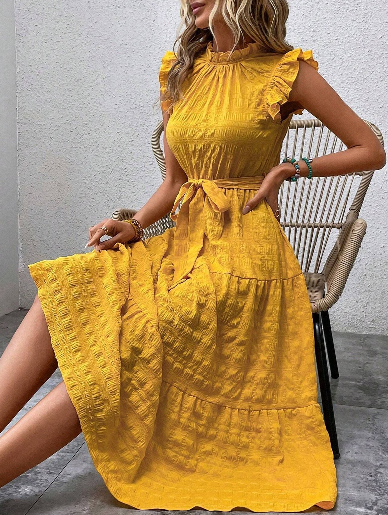 Yellow ruffled flutter sleeve dress by Christine Brewer featuring tie waist and textured fabric design.