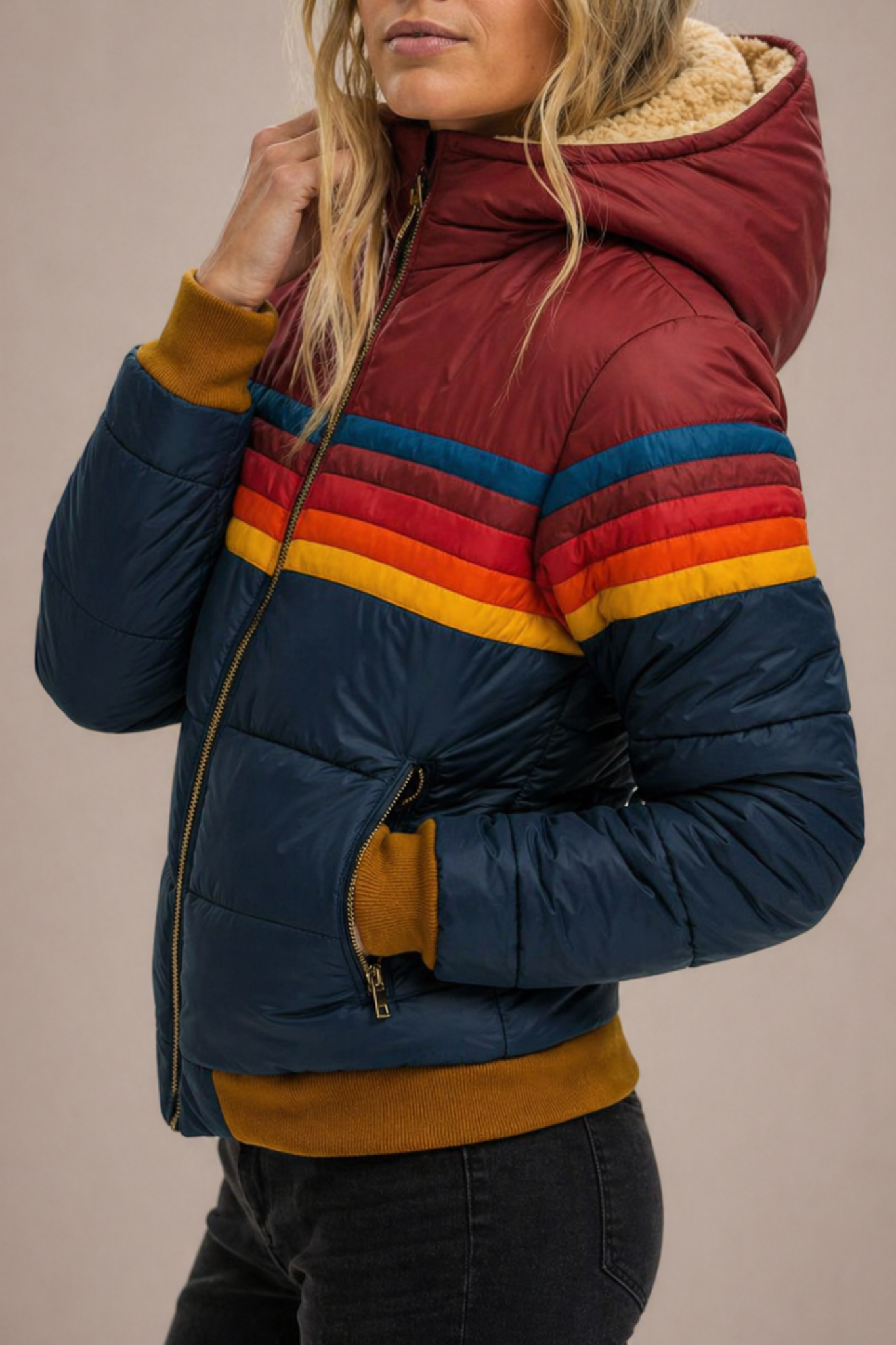 Woman wearing the Clara hooded quilted puffer jacket for women by Christine Brewer, showcasing its quilted design and cozy hood.