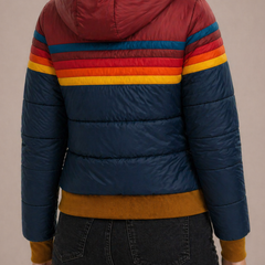 Women’s hooded quilted puffer jacket by Christine Brewer, featuring a stylish, insulated design with a high collar and front zipper.
