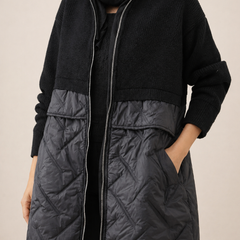Long quilted puffer jacket for women by Christine Brewer, featuring a stylish padded design and a cozy, insulated fit.
