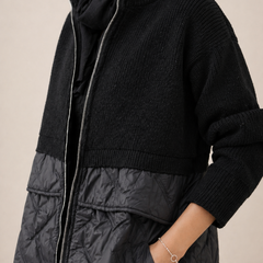 Long quilted puffer jacket for women by Christine Brewer, featuring a stylish, insulated design with a high collar and quilted pattern.