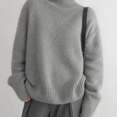 Cream-colored women's turtleneck sweater by Christine Brewer, featuring a cozy, chunky knit design perfect for fall and winter.