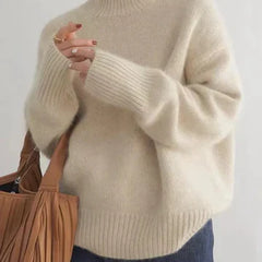 Cream-colored Christine Brewer Cara turtleneck sweater for women, featuring a cozy, chunky knit design suitable for fall and winter.