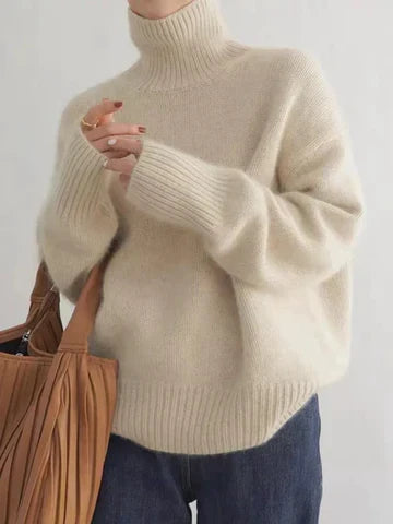 Cream-colored Christine Brewer Cara turtleneck sweater for women, featuring a cozy, chunky knit design suitable for fall and winter.