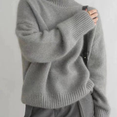 Cream-colored women's turtleneck sweater by Christine Brewer, featuring a cozy, loose-fit wool knit design for fall and winter.