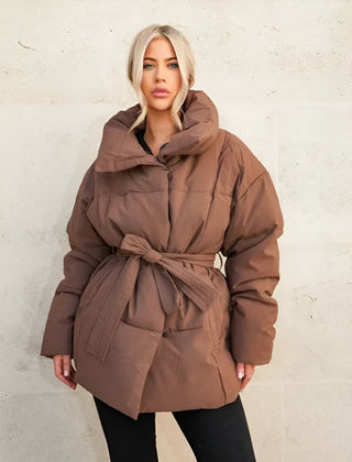Alice belted puffer jacket for women by Véron the Label featuring a quilted design and a waist belt, in a stylish winter coat style.