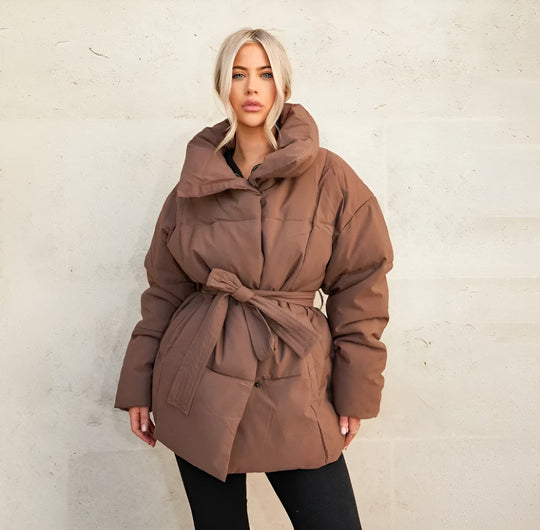Alice belted puffer jacket for women by Véron the Label featuring a quilted design and a waist belt, in a stylish winter coat style.