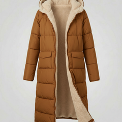 Brown Iris long puffer jacket for women by Christine Brewer, shown on a model with a winter outdoor setting.