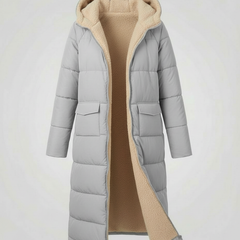 Light gray Iris long puffer jacket for women by Christine Brewer, showcasing its quilted design and cozy fit.