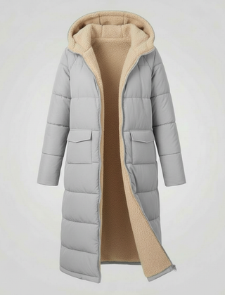 Light gray Iris long puffer jacket for women by Christine Brewer, showcasing its quilted design and cozy fit.