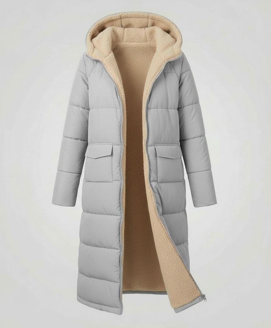 Light gray Iris long puffer jacket for women by Christine Brewer, showcasing its quilted design and cozy fit.