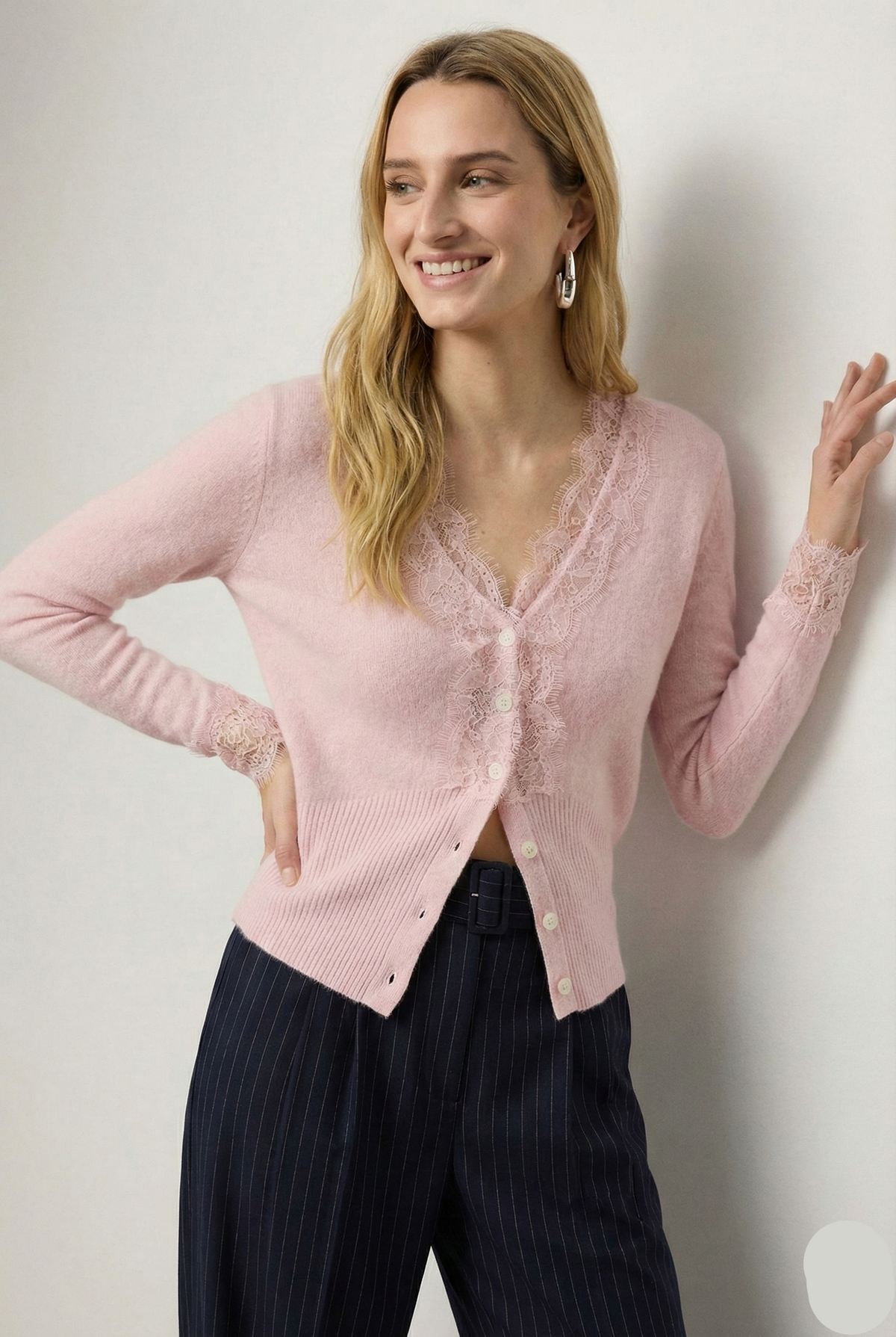 Elsa cashmere cardigan for women by Christine Brewer, soft knit with a relaxed fit, shown in a light neutral color.
