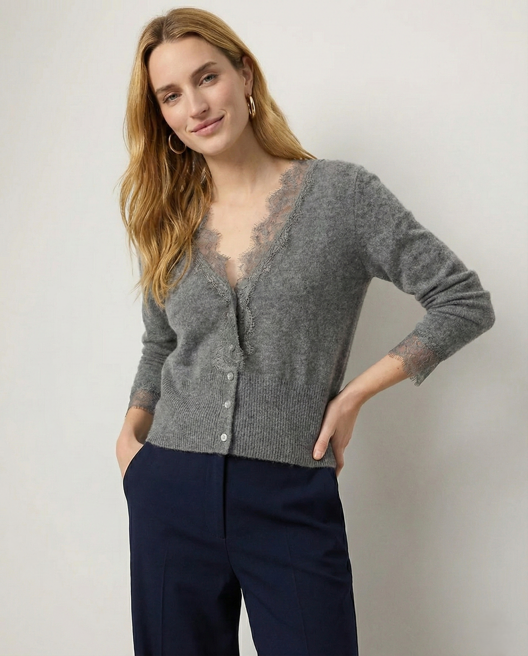 Cream-colored Elsa cashmere cardigan for women by Christine Brewer, shown on a model with a soft, cozy knit texture.